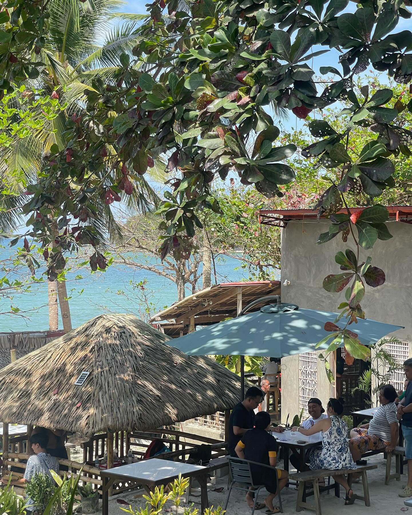 Open-air dining area shaded by trees